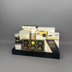Premium corporate sweet and savoury gift basket featuring gourmet cheese, Provisions jam, chocolate truffles, and luxury snacks arranged on a black rectangular tray.
