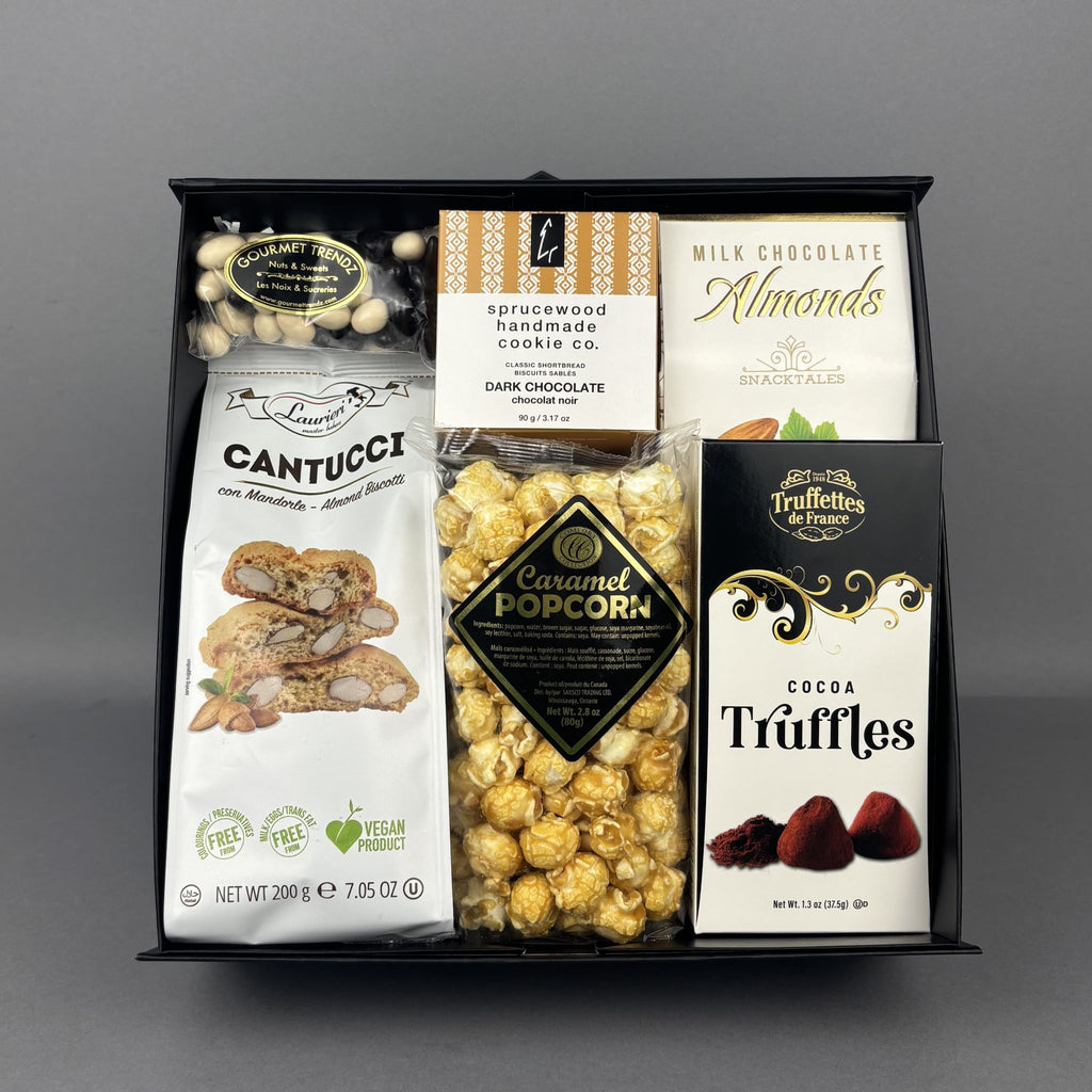 A gourmet chocolate and snack gift box, featuring almond biscotti, Sprucewood Handmade cookies dark chocolate chip, milk chocolate almonds, caramel popcorn, and Chocolate Truffles.