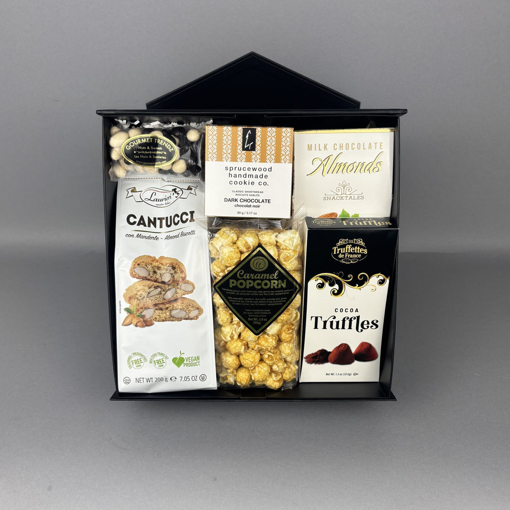 A gourmet chocolate and snack gift basket presented in a black container. The basket contains a bag of Cantucci almond biscotti, Sprucewood Handmade Cookies, caramel popcorn, and other assorted sweets. 
