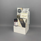 A gift hamper set in a white rustic wooden basket, containing Castello Brie cheese, a box of milk chocolate almonds, and a bag of Cantucci almond biscotti, and Provisions Red Pepper jelly.